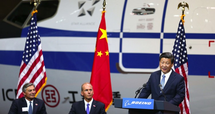 Chinese President Xi Jinping, far right, addresses the crowd at Boeing on Wednesday, September 23, 2015 in Everett, Wash. At far left are, Boeing Commercial Airplanes president and CEO , Ray Conner, and Boeing president and CEO, Dennis Muilenberg (CQ).     STATE VISIT BY CHINESE PRESIDENT XI JINPING - BOEING EVERETT PLANT - 150253 - 092315  (John Lok / The Seattle Times)