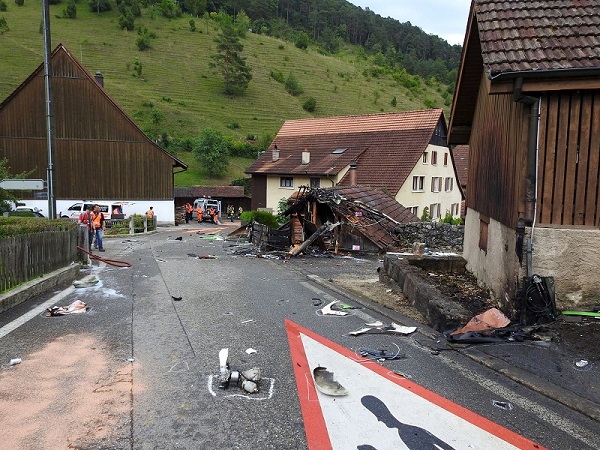 Parts of one of two planes which crashed during an air show are seen in the village of Dittingen, Switzerland in this handout photo provided by Kantonspolizei Basel Landschaft on August 23, 2015. Two small planes crashed at an air show in Dittingen, Switzerland, on Sunday, killing at least one person, police said. REUTERS/Kantonspolizei Basel Landschaft/Handout via Reuters ATTENTION EDITORS - FOR EDITORIAL USE ONLY. NOT FOR SALE FOR MARKETING OR ADVERTISING CAMPAIGNS. THIS IMAGE HAS BEEN SUPPLIED BY A THIRD PARTY. IT IS DISTRIBUTED, EXACTLY AS RECEIVED BY REUTERS, AS A SERVICE TO CLIENTS. REUTERS IS UNABLE TO INDEPENDENTLY VERIFY THE AUTHENTICITY, CONTENT, LOCATION OR DATE OF THIS IMAGE.